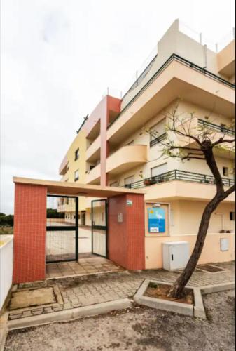 a building with a tree in front of it at BLife RYA private rooms - Airport stay in Faro