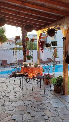 a patio with a table and chairs on a patio at Villa dos Corcéis in Esposende
