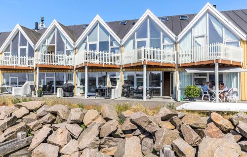 a row of houses on the beach with rocks at Lovely Home In Hasle With Wifi in Hasle