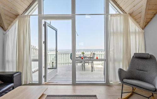 a living room with a large glass door leading to a deck at Lovely Home In Hasle With Wifi in Hasle