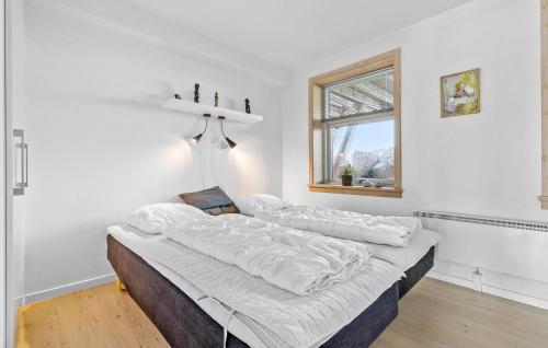 a large bed in a white room with a window at Lovely Home In Hasle With Wifi in Hasle
