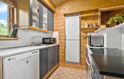 a kitchen with a white refrigerator and a sink at 3 Bedroom Cozy Home In Eskebjerg in Eskebjerg