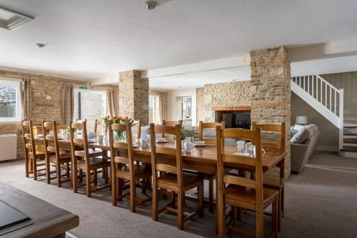 a dining room with a large wooden table and chairs at Stanton House, 6 bedroom, 5 bath in Cheltenham