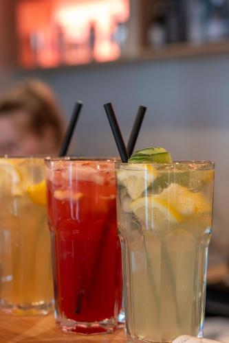 a group of three cocktails sitting on a table at Hotel Anna Villa in Balatonföldvár