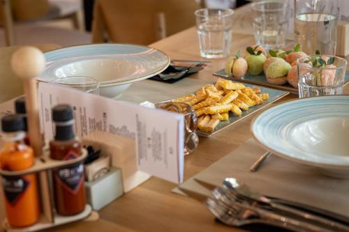 a table with plates of food on a table at Hotel Anna Villa in Balatonföldvár