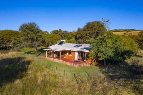 a house in the middle of a field at Kokopelli farm in Magaliesburg