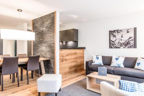 a living room with a couch and a table at Titlis Resort in Engelberg