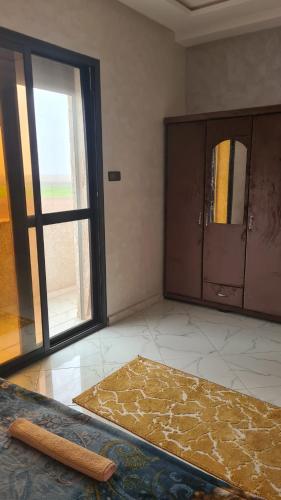 an empty room with a large window and a door at Rooms in shared apartment close to CMN-Airport in Dah Hammou Ben Cheïkh
