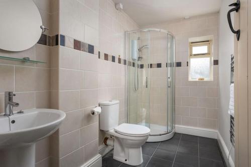 a bathroom with a toilet and a sink and a shower at Stanway House, 8 bedroom, 8 Bath in Cheltenham
