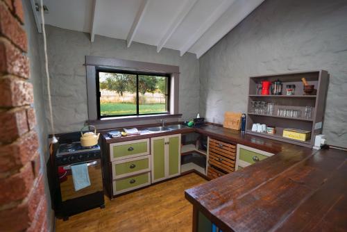 a kitchen with a counter and a sink and a window at Kokopelli farm in Magaliesburg