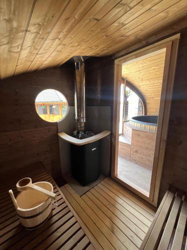 a small bathroom with a tub and a window at Pensiunea Roxana in Buzău