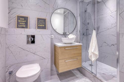 a bathroom with a toilet and a sink and a mirror at Short Time Suites Toulon Centre 2 " LE COSY" Check-in auto in Toulon