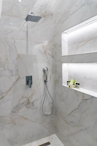 a bathroom with a shower with a shower head at Nikos Studios in Keri