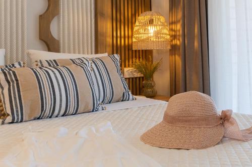 a hat sitting on top of a bed at Nikos Studios in Keri