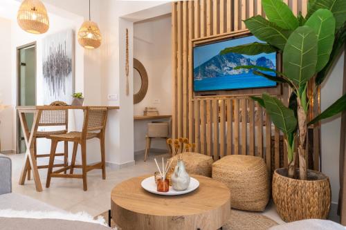 a living room with a table and a tv at Nikos Studios in Keri