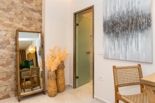 a room with a mirror and a table and chairs at Nikos Studios in Keri