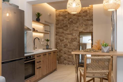 a kitchen with a counter and a table with chairs at Nikos Studios in Keri