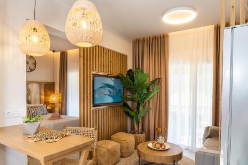 a living room with a table and a couch at Nikos Studios in Keri