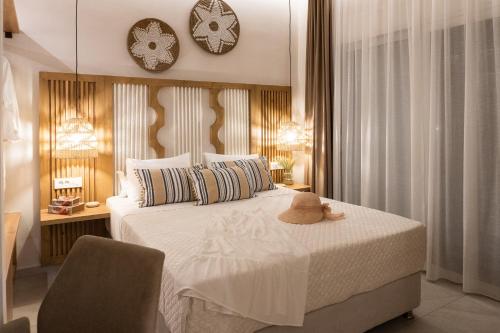 a bedroom with a bed with a hat on it at Nikos Studios in Keri