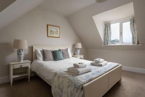 a bedroom with a bed with towels on it at Stanway House, 8 bedroom, 8 Bath in Cheltenham
