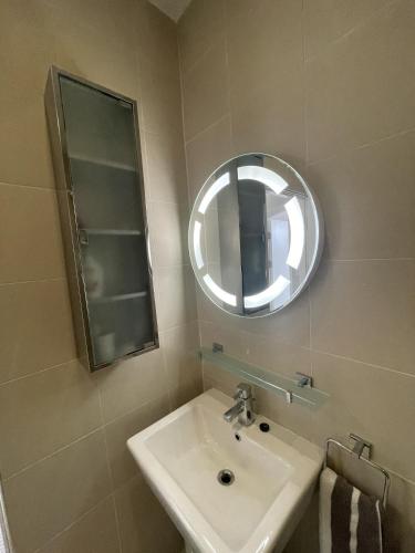 a bathroom with a sink and a mirror at 21 Victoria, Kilkee in Kilkee