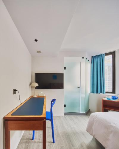 a bedroom with a ping pong table and a bed at The Blue by Just Inn in Taipei