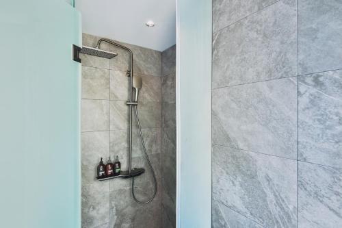 a bathroom with a shower with a glass door at The Blue by Just Inn in Taipei