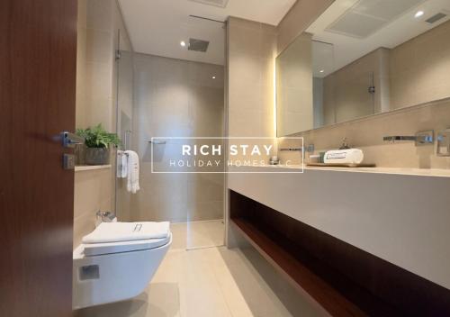 a bathroom with a white toilet and a mirror at Phenomenal 1BR at Marina Gate 2 in Dubai Marina by Rich Stay in Dubai