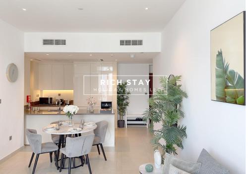a dining room and kitchen with a table and chairs at Phenomenal 1BR in Marina Gate 2,Full Marina View in Dubai