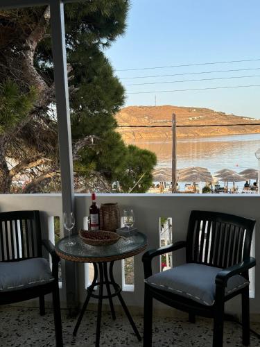 a table and chairs on a balcony with a view of the beach at Akti Rooms And Studios in Livadion