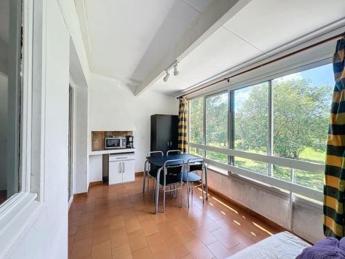 une chambre avec une table et une cuisine avec une fenêtre dans l'établissement 3369-Appartement 4 couchages avec piscine, tennis, à Argelès-sur-Mer