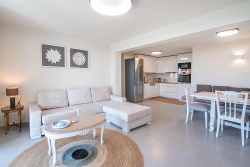 a living room with a couch and a table at Maya Luxury Suite in Aegenitissa