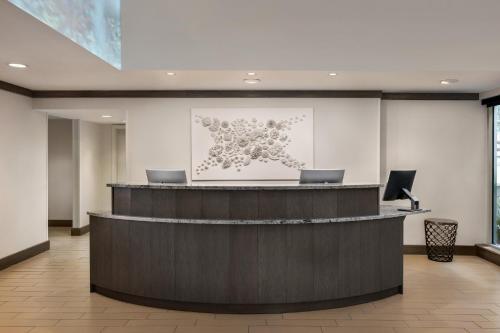 a lobby with a reception desk with a picture of flowers at Holiday Inn Resort Jekyll Island by IHG in Jekyll Island