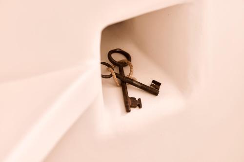 a key hanging on a wall at Windmill Karamitsos since 1859 in Tripití