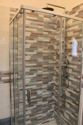 a shower with a glass door in a bathroom at Centro storico Bed and Breakfast in Vico del Gargano