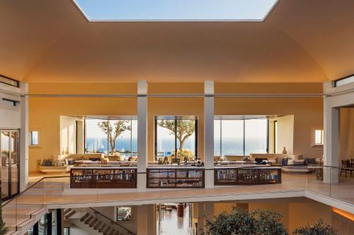 a large lobby with a pool and a lot of windows at One&Only Kéa Island in Pisses