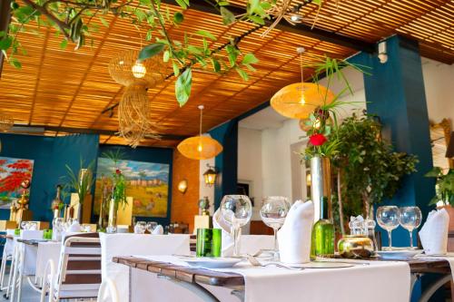 a dining room with white tables and wine glasses at La Varangue in Antananarivo