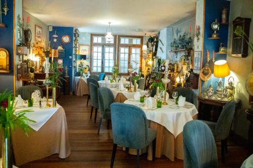 a restaurant with white tables and blue chairs at La Varangue in Antananarivo
