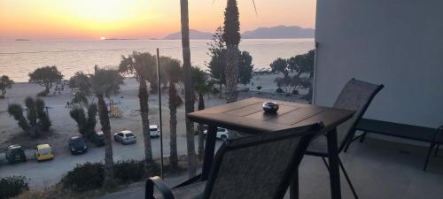 a table and chairs with a view of the ocean at Irene Studios in Mastichari