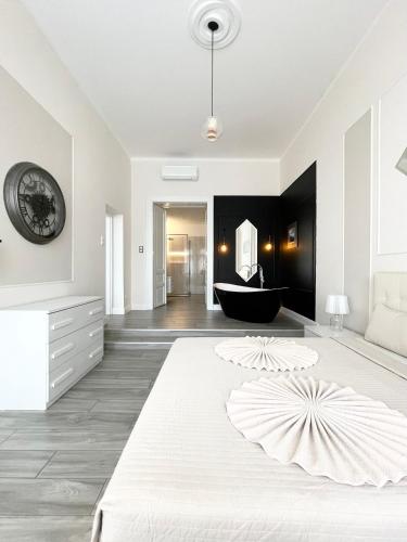 a bedroom with a large bed and a bath tub at Trigon Palace in Budapest