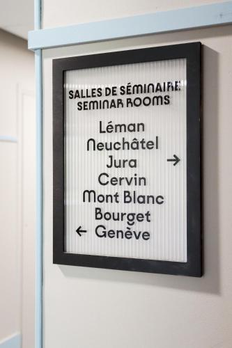a framed sign on a wall with words on it at Hôtel Best of Both - Divonne-les-Bains in Divonne-les-Bains