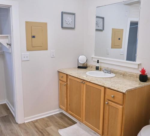 a bathroom with a sink and a mirror at Cozy Studio - Walk to the Beach! in Jacksonville Beach