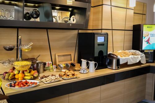 a buffet with many different types of food on a counter at Sándor Hotel in Pécs
