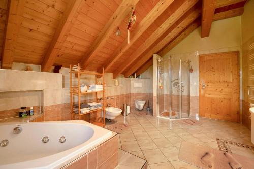 a large bathroom with a tub and a toilet at Haus Emanuel in Weilerbach