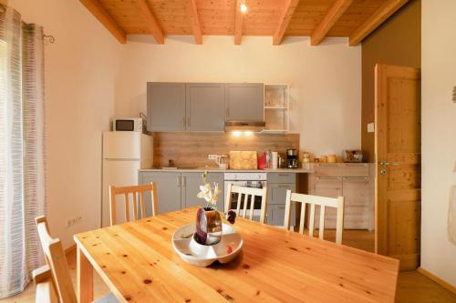 a kitchen and dining room with a wooden table and chairs at Haus Emanuel in Weilerbach
