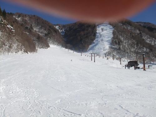 a snow covered ski slope with a ski lift at Ryokan Tanaka in Takayama