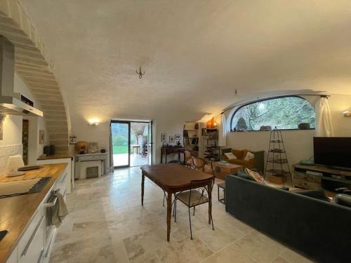 un salon avec un canapé vert et une table dans l'établissement Petit havre de paix en pleine nature cévenole, à Monoblet