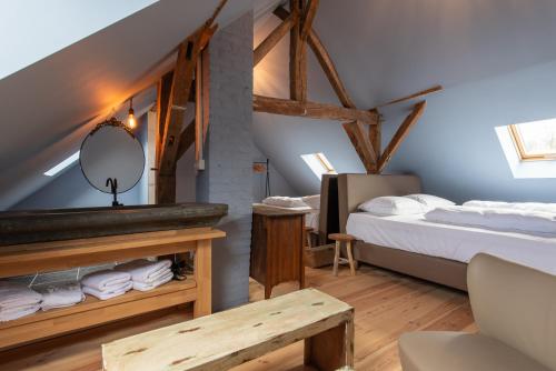 a hotel room with a bed and a mirror at Maisons de vacances Le Vieux Marronnier in Dinant