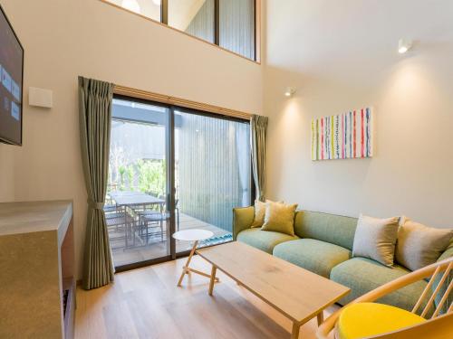 a living room with a couch and a table at Rakuten STAY VILLA Nasu in Nasu