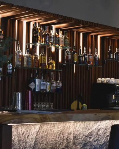 a bar with a bunch of bottles on the wall at Kechi Apart, Hotel Nice View No 139, 6th floor in Tsaghkadzor